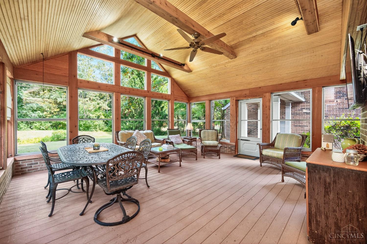 Timber vaulted sunroom overlooking mature trees at 10070 Carrousel Court, Symmes Township.