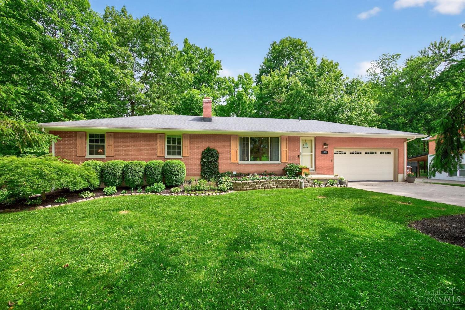Brick ranch with timber shutters and mature trees at 1968 Forest Dell Drive, Beavercreek Township.