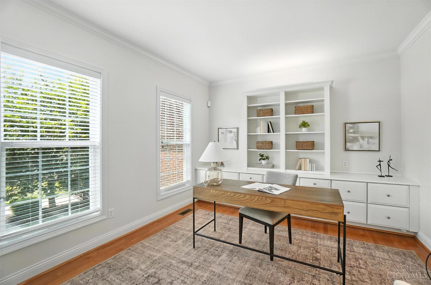 White built-in shelves and a timber desk in the home office at 124 Isabella Court.