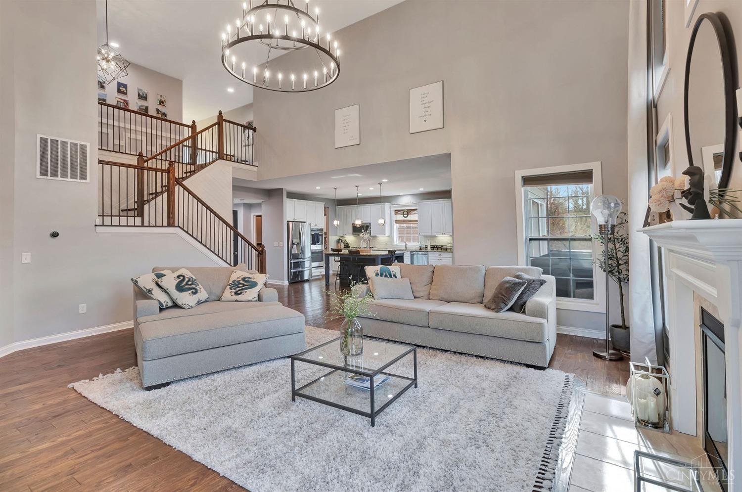 Neutral seating and an open staircase in the great room at 4853 Whispering Creek Court.