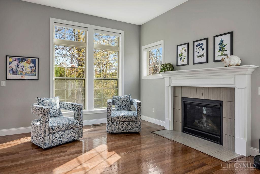 Sunlit sitting area beside a white fireplace at 6190 Winding Creek Boulevard, Liberty Township.